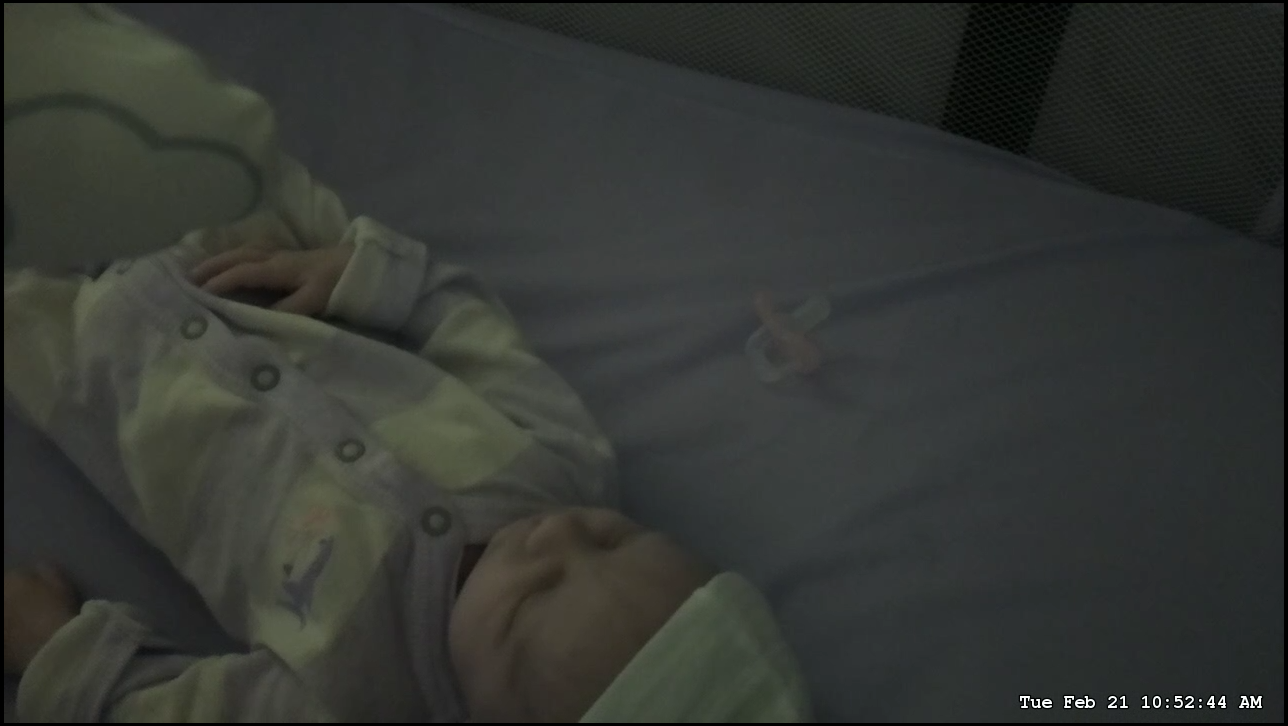 A picture of a baby in dim light